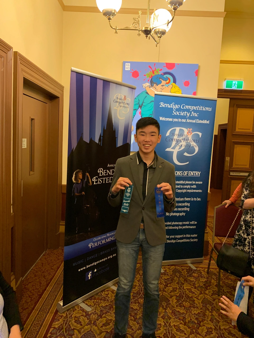 Isaac holding ribbons at the Bendigo Eisteddfod