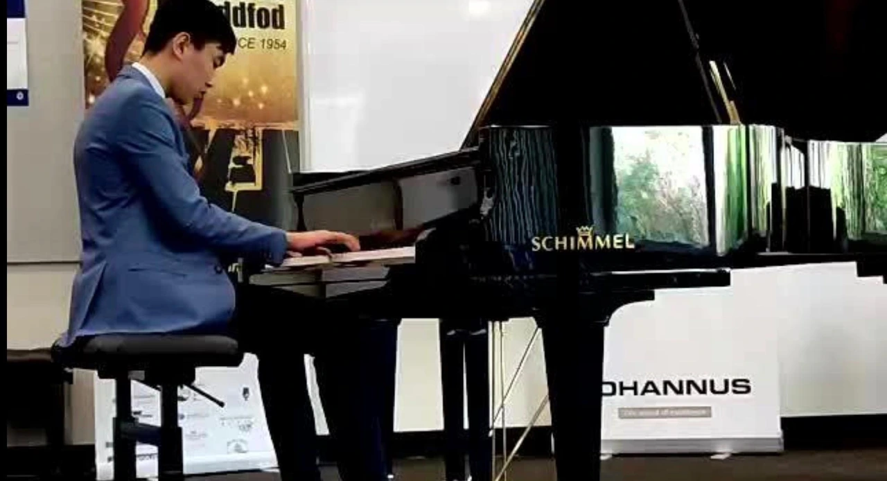 Isaac playing a Schimmel grand piano at the Ringwood Eisteddfod
