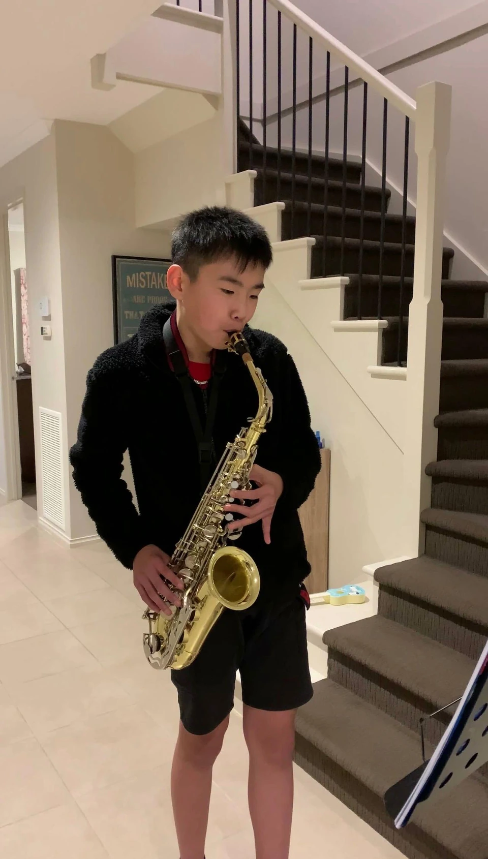 Isaac playing saxophone at home